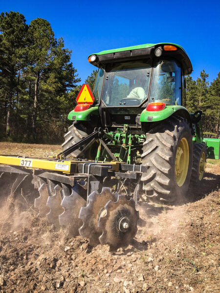 Isang imahe ng isang traktor na nagbubungkal ng lupa